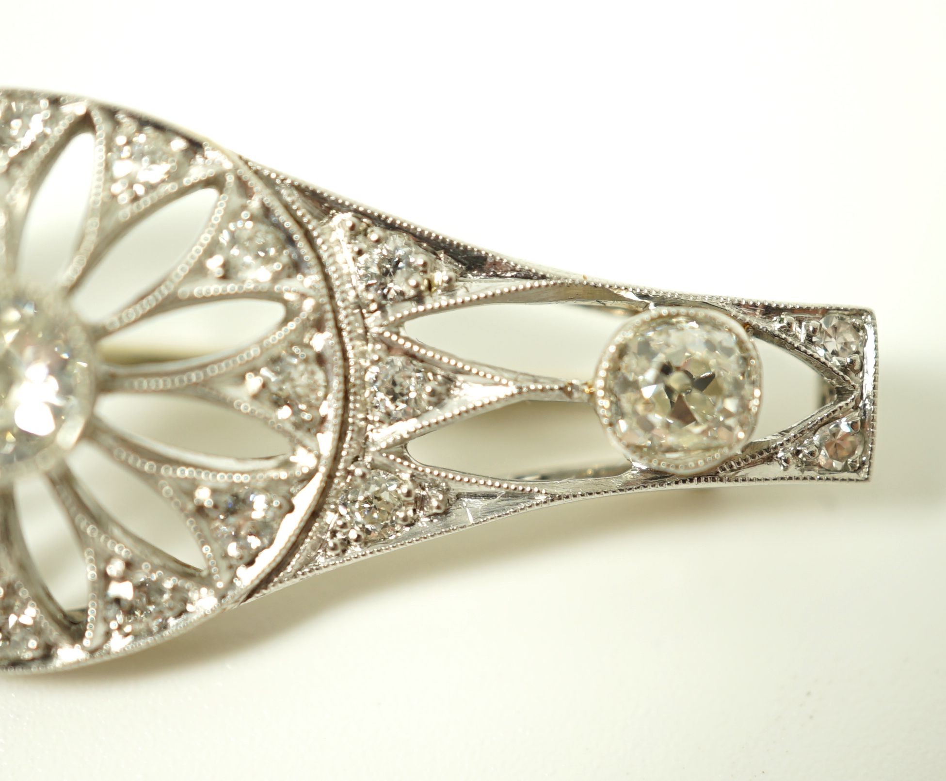 A 1920's pierced white gold and diamond cluster set brooch